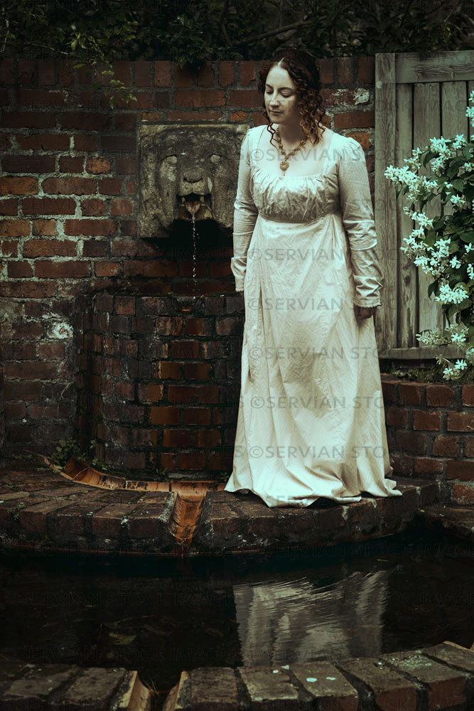 Regency woman wearing a day dress and standing by a fountain (Agnes 69 –  Servian Stock Images