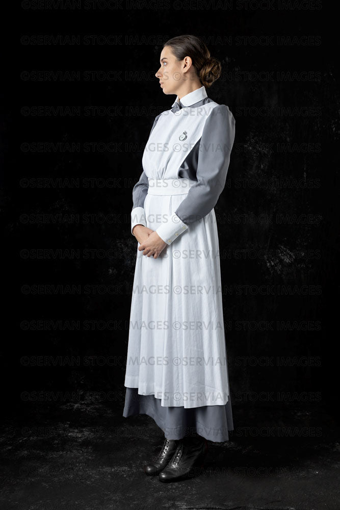 World War 1 nurse in grey uniform dress with a white apron (Sarah542) –  Servian Stock Images