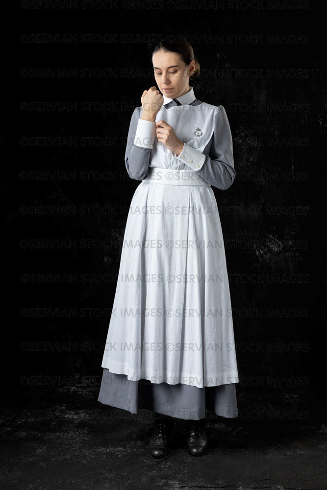 World War 1 nurse in grey uniform dress with a white apron (Sarah551) –  Servian Stock Images