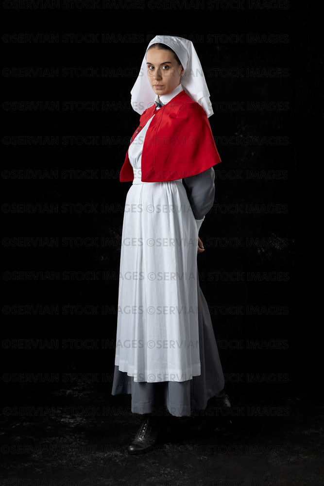World War 1 nurse in grey uniform dress with a white apron and red cap   Servian Stock Images