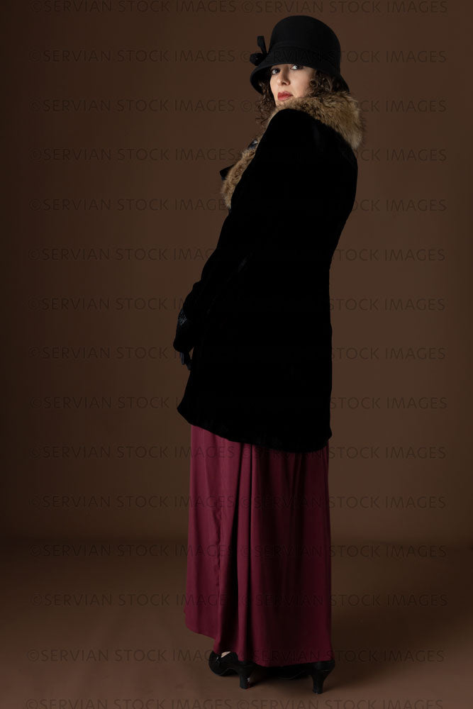 1920s woman wearing a black velvet coat and cloche hat (Emma 296)
