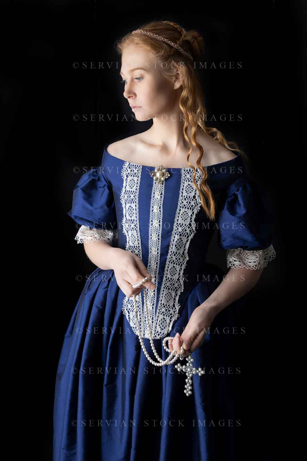 Renaissance woman in a blue silk dress against a black backdrop (Laure Servian Stock Images Renaissance woman in a blue silk dress against a black backdrop (Laure Servian Stock Images