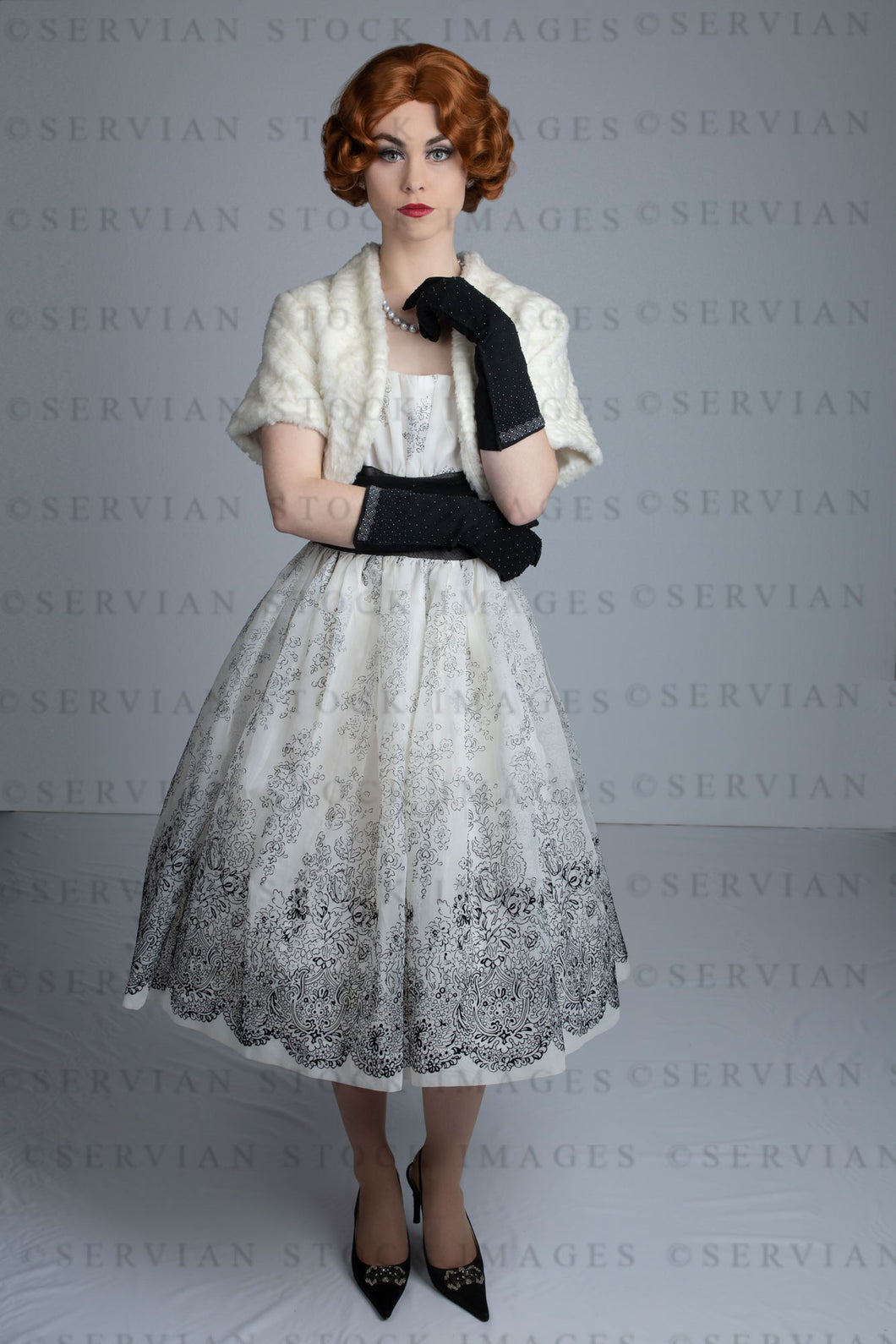 1950s woman in vintage dress, white fur shrug, and black gloves (Lacey 2503)