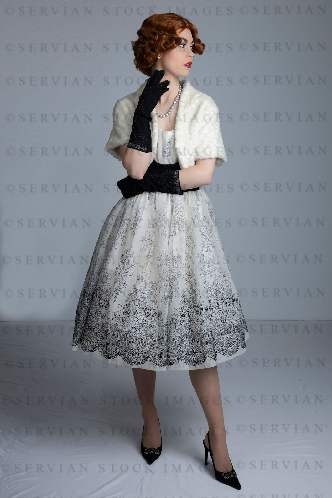 1950s woman in vintage dress, white fur shrug, and black gloves (Lacey 2517)
