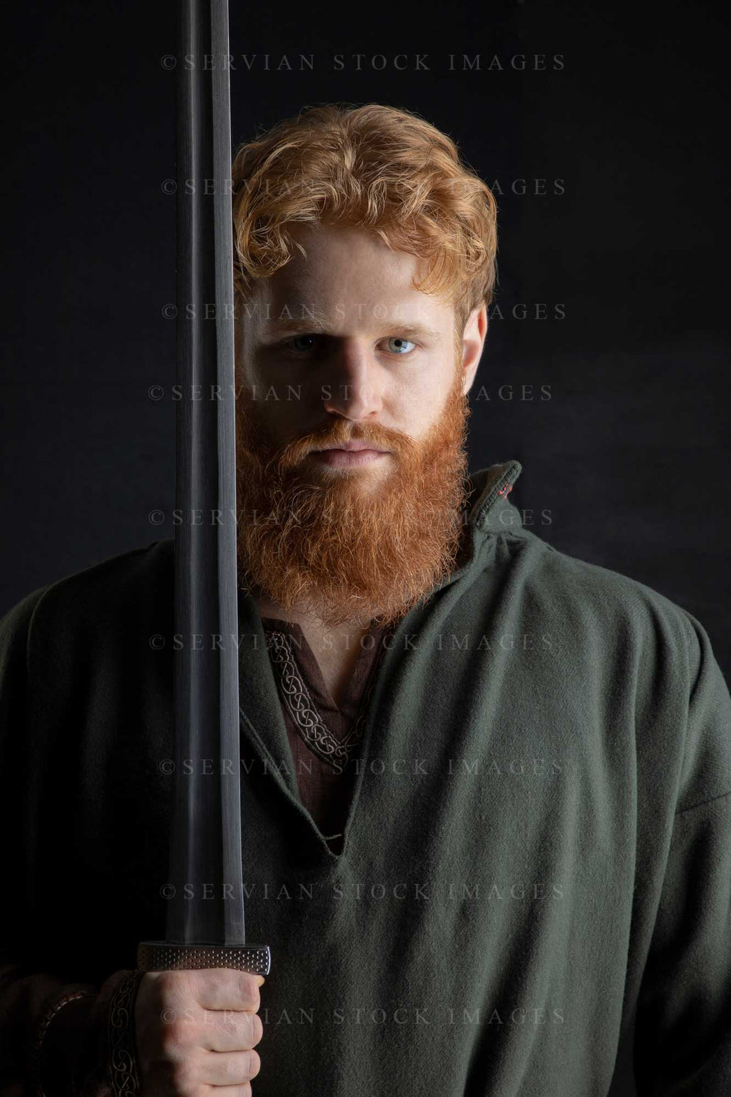 Viking or high fantasy man with red hair and beard holding a sword against a black backdrop (Luke 3111