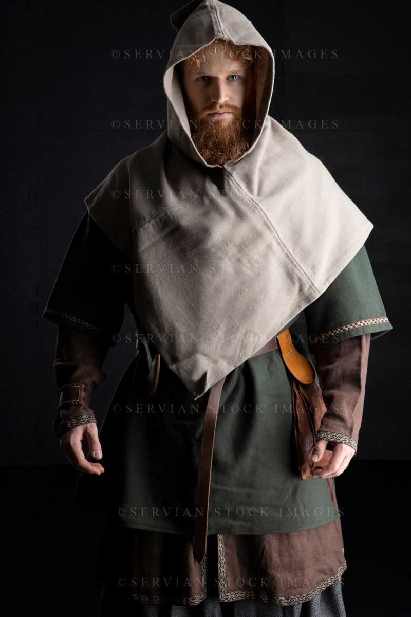 Viking or high fantasy man with red hair and beard wearing a historically accurate Viking costume against a black backdrop (Luke 3155)