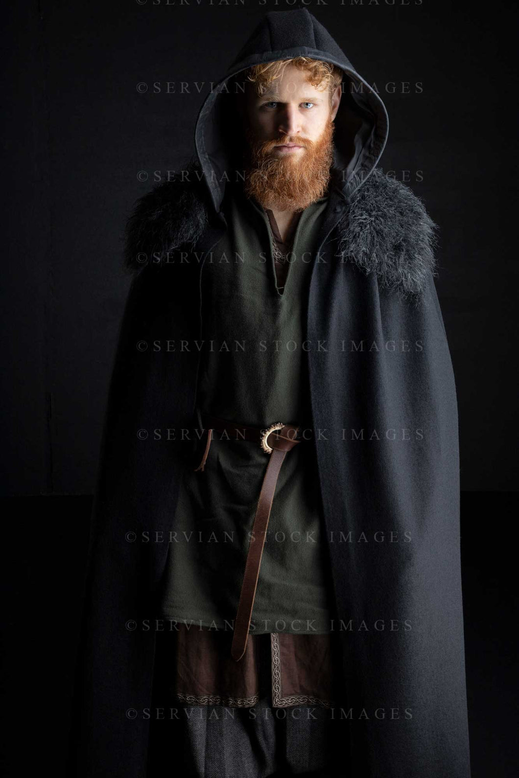 Viking or high fantasy man with red hair and beard wearing a black cape with fur against a black backdrop (Luke 3164)