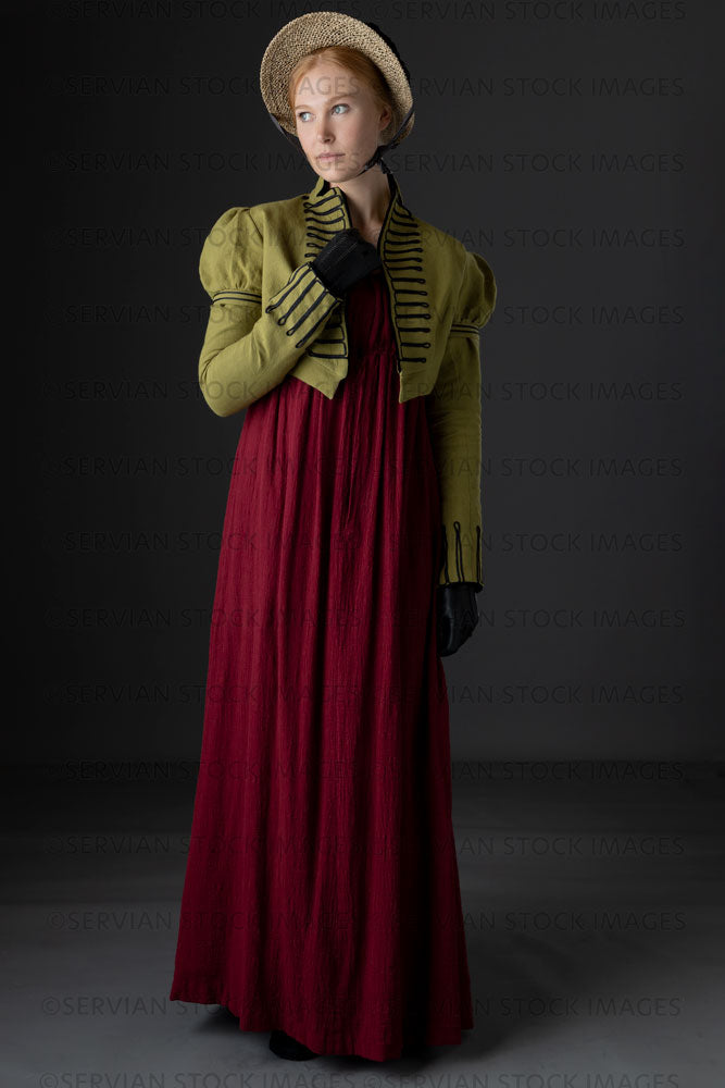 Regency woman wearing a red dress with a green linen spencer and bonne   Servian Stock Images