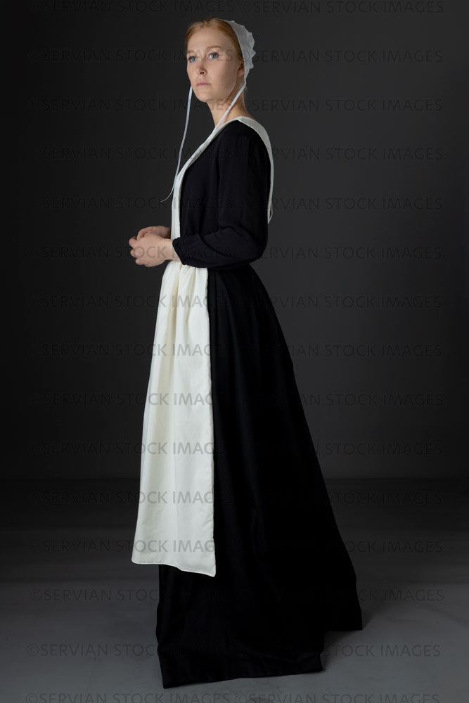Amish woman wearing a black dress with a white apron and cap (Lauren 0769)
