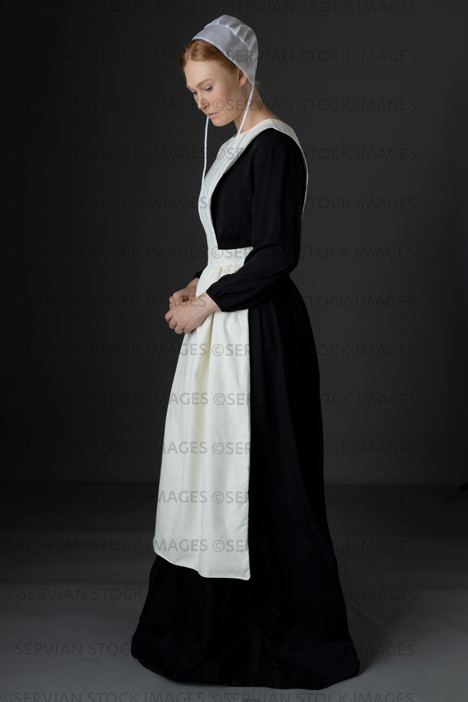 Amish woman wearing a black dress with a white apron and cap (Lauren 0771)