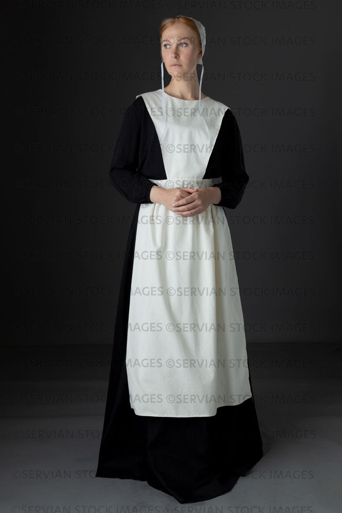 Amish woman wearing a black dress with a white apron and cap (Lauren 0777)