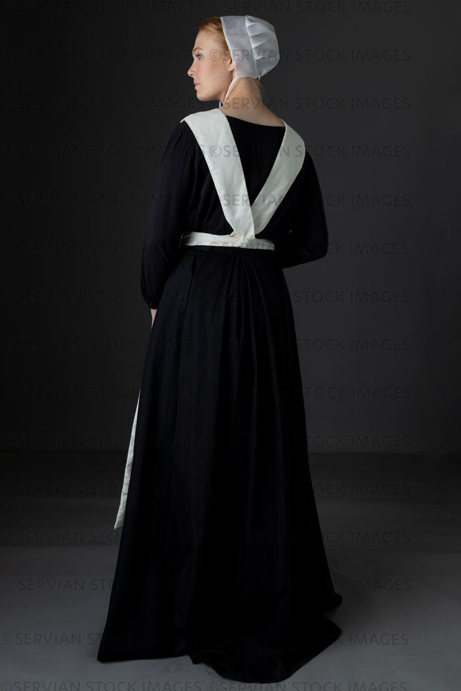 Amish woman wearing a black dress with a white apron and cap (Lauren 0784) Amish woman wearing a black dress with a white apron and cap (Lauren 0784)