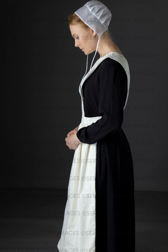 Amish woman wearing a black dress with a white apron and cap (Lauren 0794)