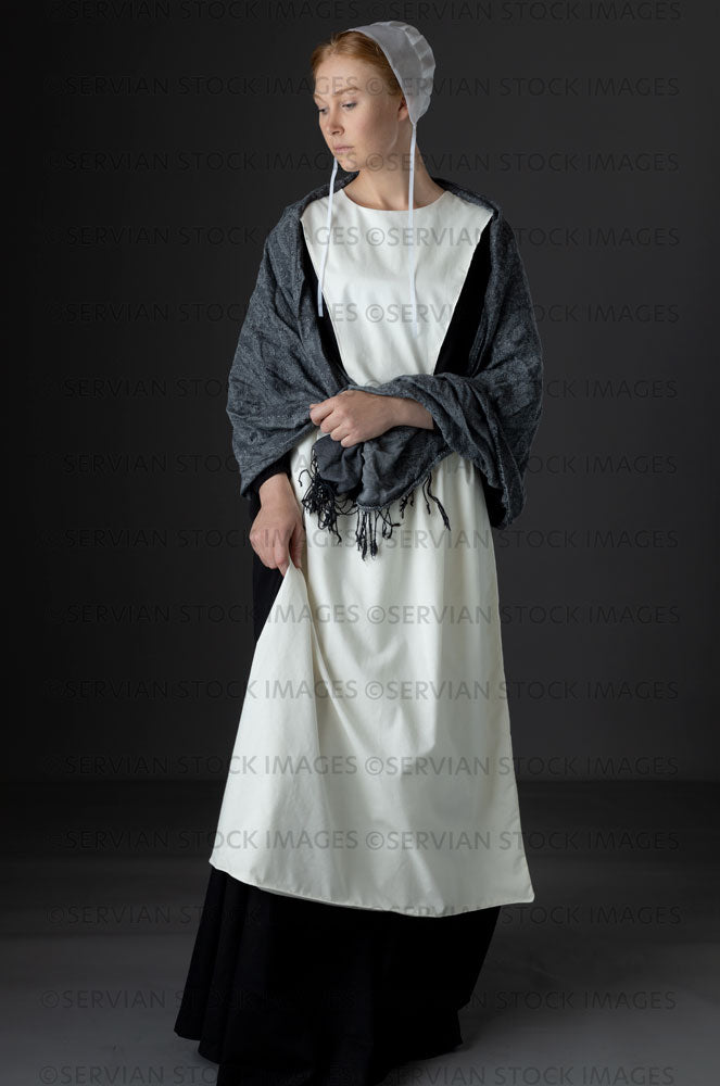 Amish woman wearing a black dress with a white apron and cap (Lauren 0 –  Servian Stock Images