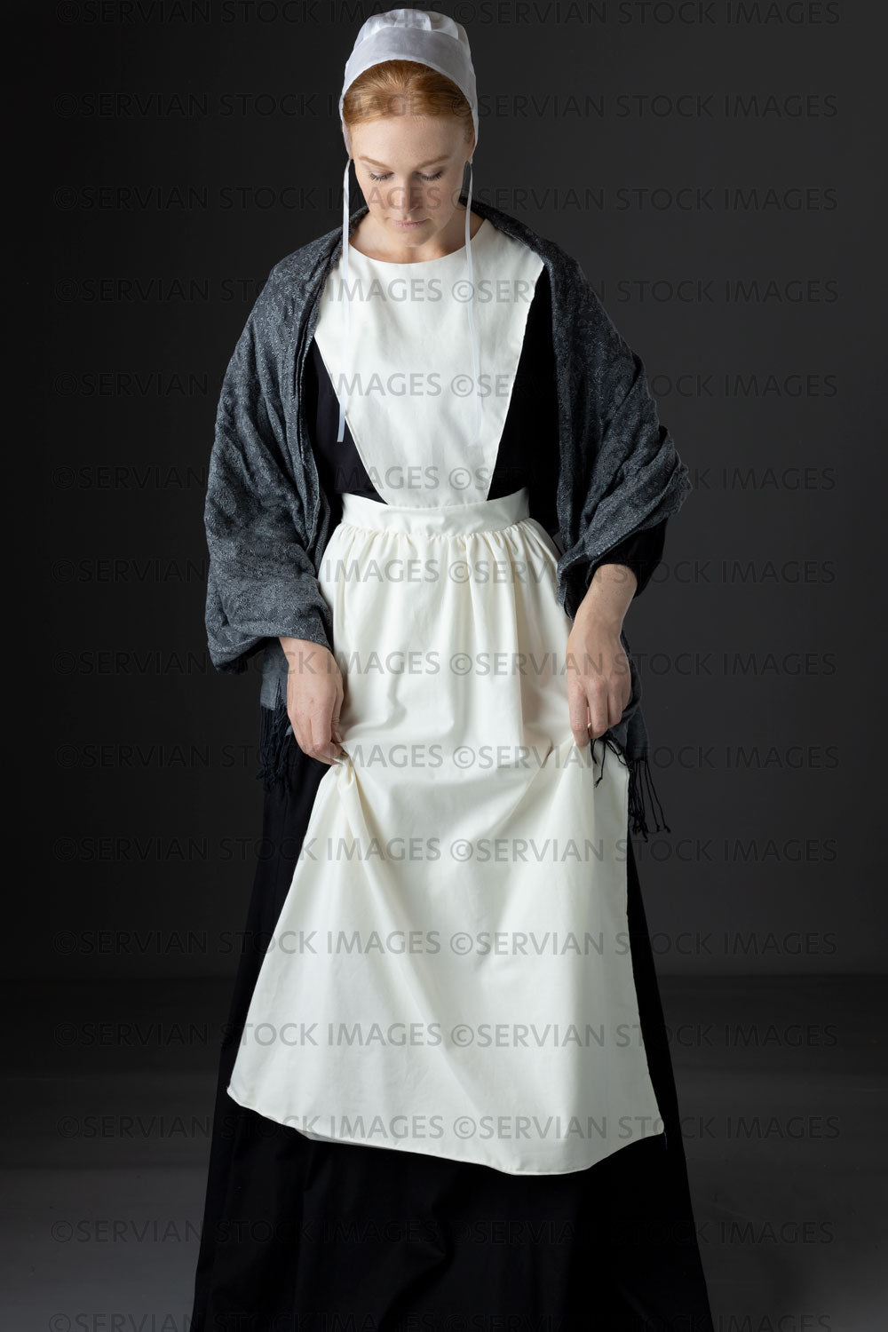 Amish woman wearing a black dress with a white apron and cap (Lauren 0813)