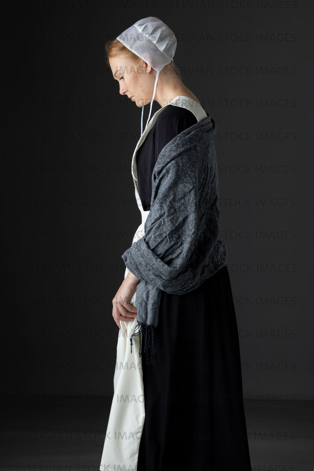 Amish woman wearing a black dress with a white apron and cap (Lauren 0816)