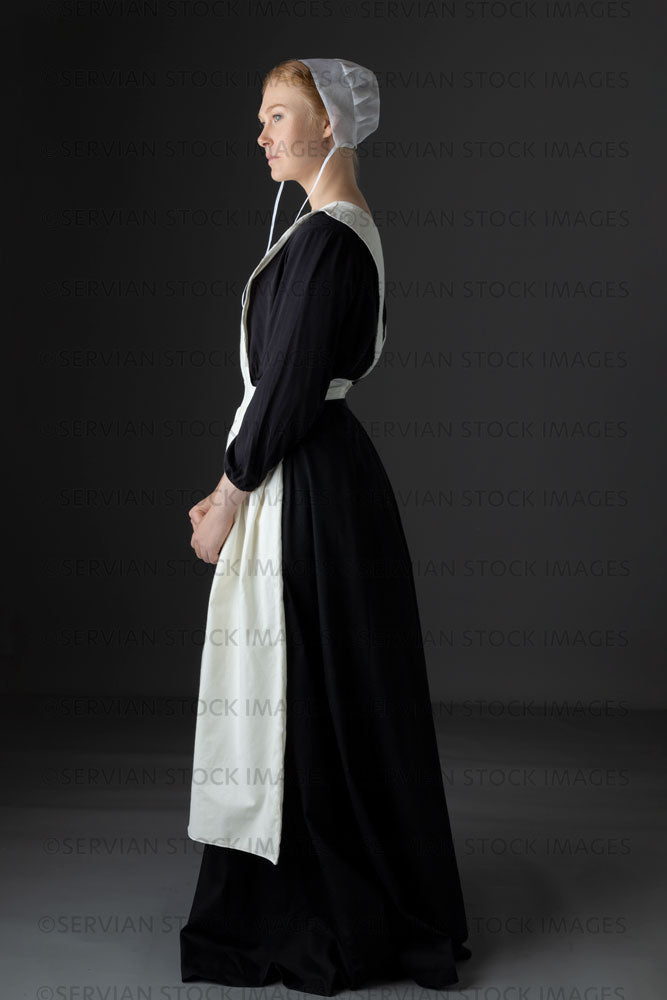 Amish woman wearing a black dress with a white apron and cap (Lauren 0 – Servian Stock Images