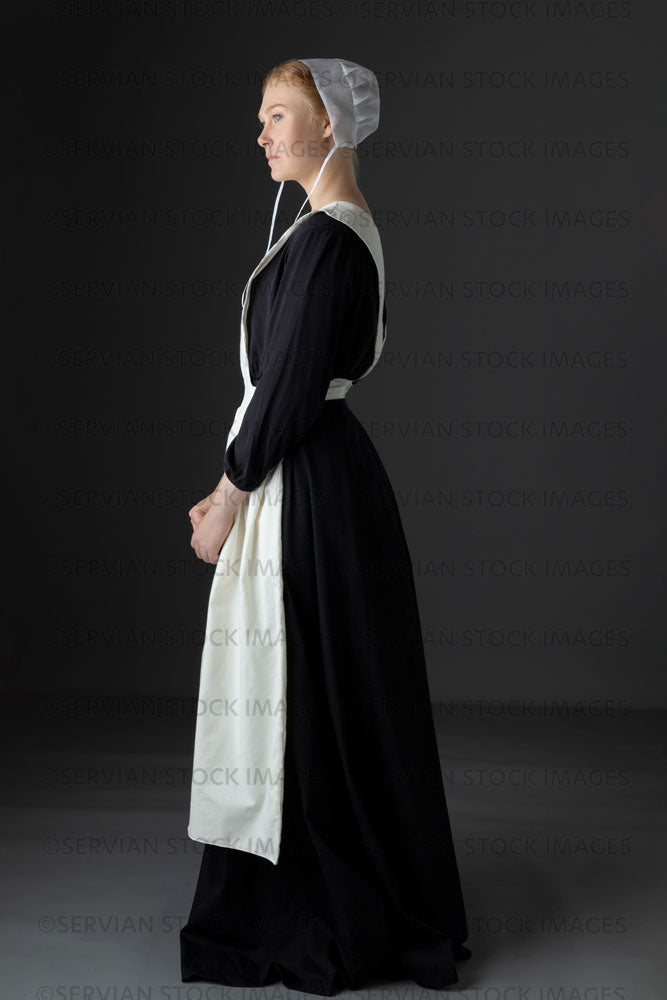 Amish woman wearing a black dress with a white apron and cap (Lauren 0835)