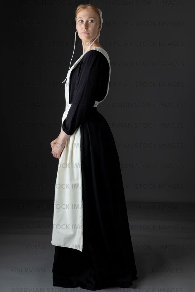 Amish woman wearing a black dress with a white apron and cap (Lauren 0837)