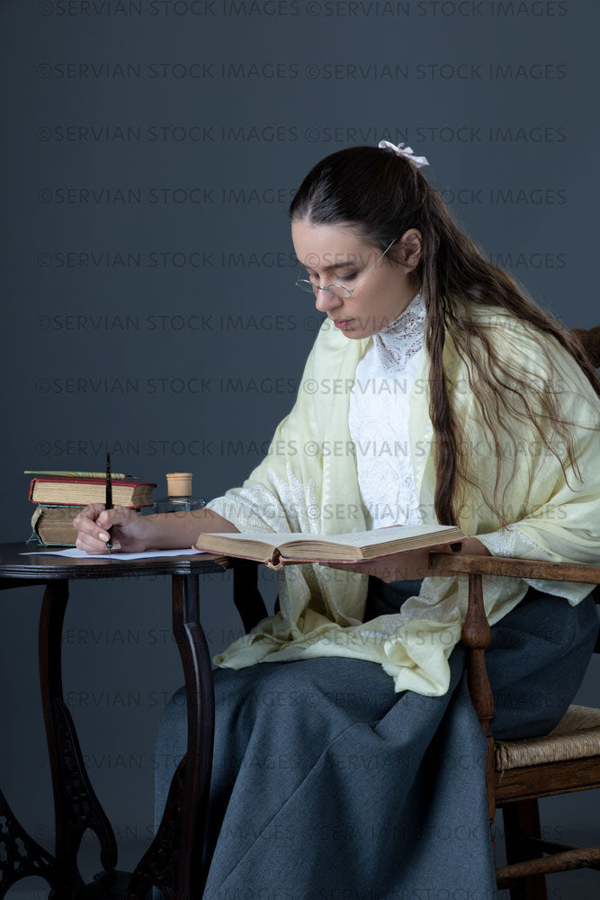 Victorian or Edwardian woman with long hair sitting at a desk writing a letter  (Sarah 1674)