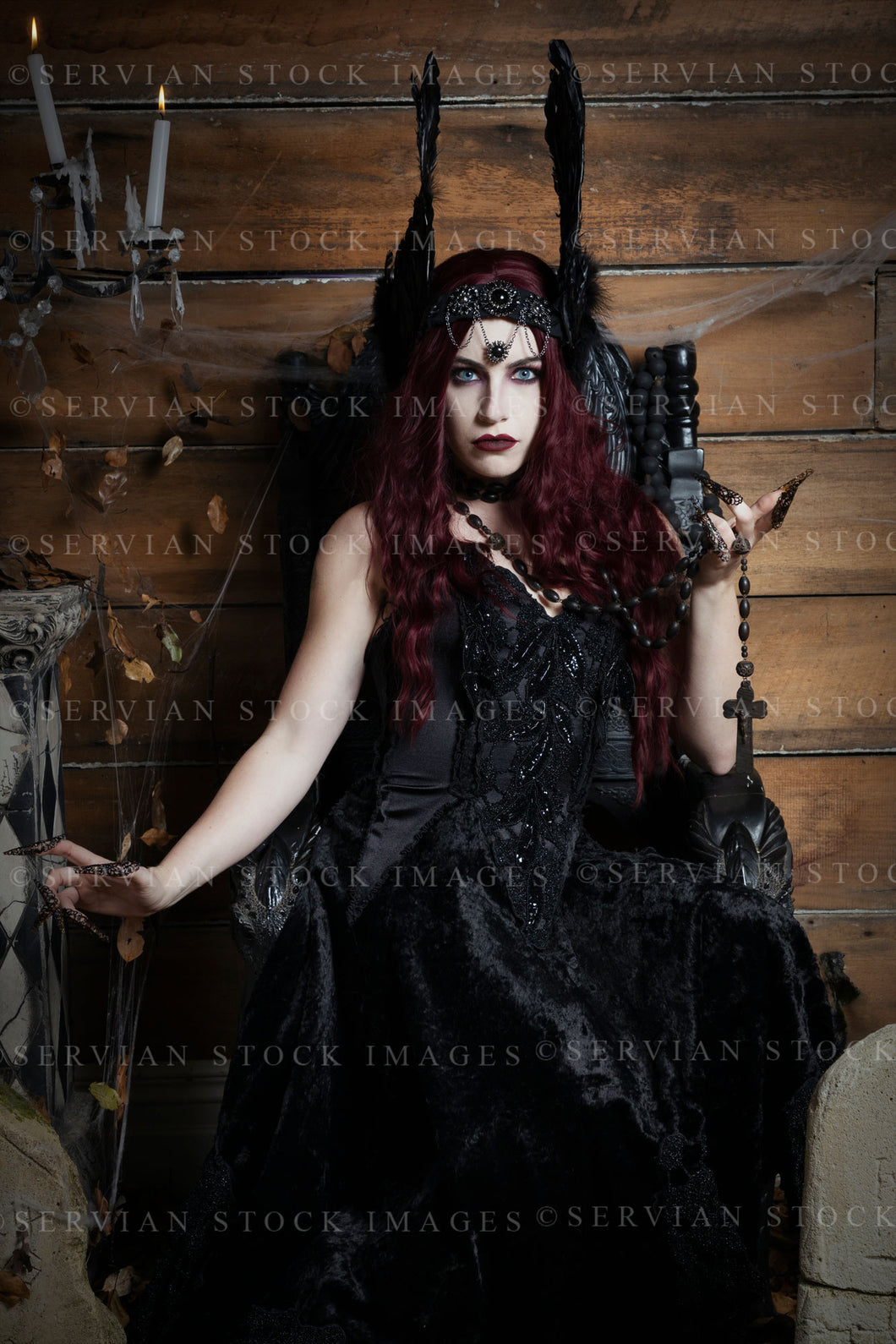 High Fantasy witch sitting on a black, gothic throne wearing a feathered headdress (Victoria 2589)