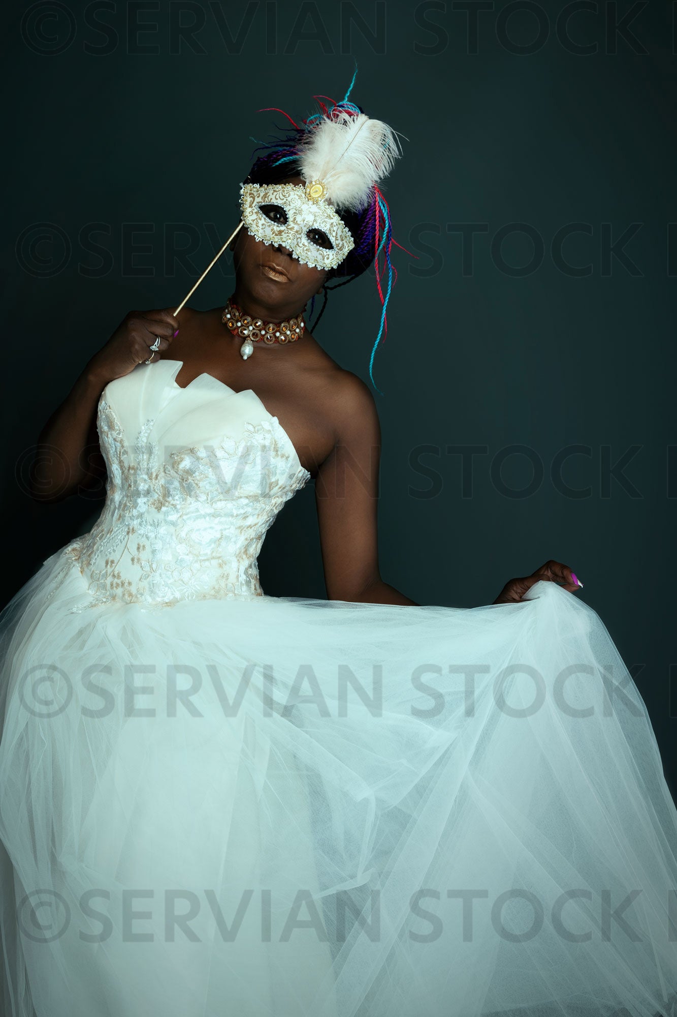 Contemporary woman wearing a white gown and masquerade mask (Marlaina Servian Stock Images Contemporary woman wearing a white gown and masquerade mask (Marlaina Servian Stock Images