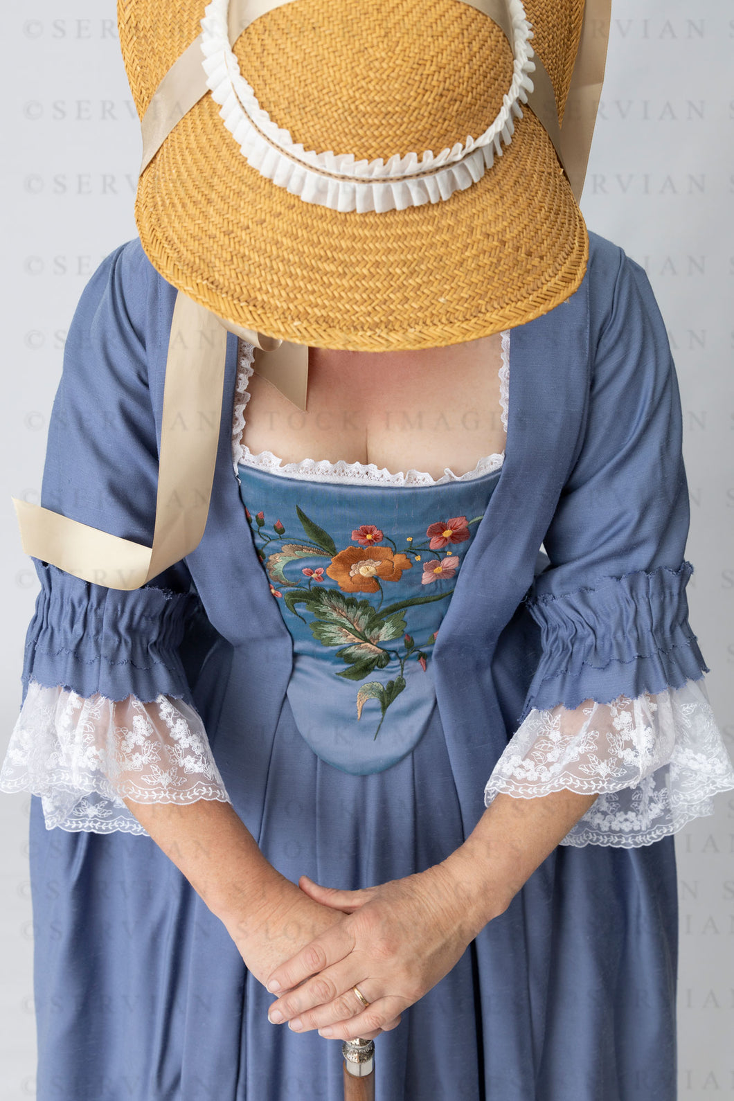 Georgian woman in a blue polonaise and underskirt with an embroidered stomacher (Tracey 5003)