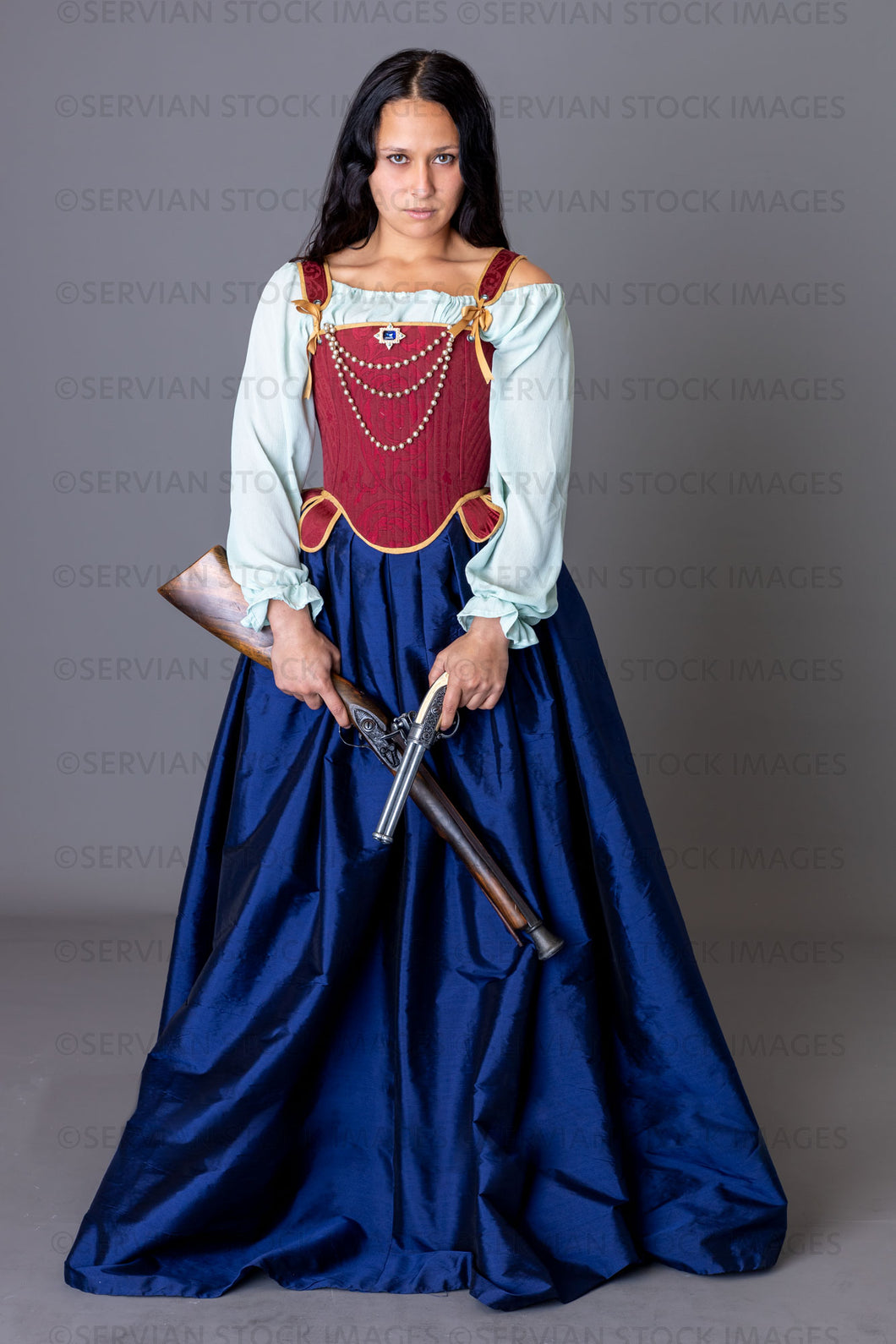 Pirate woman holding weapons against a grey backdrop (Sylvia 6033)