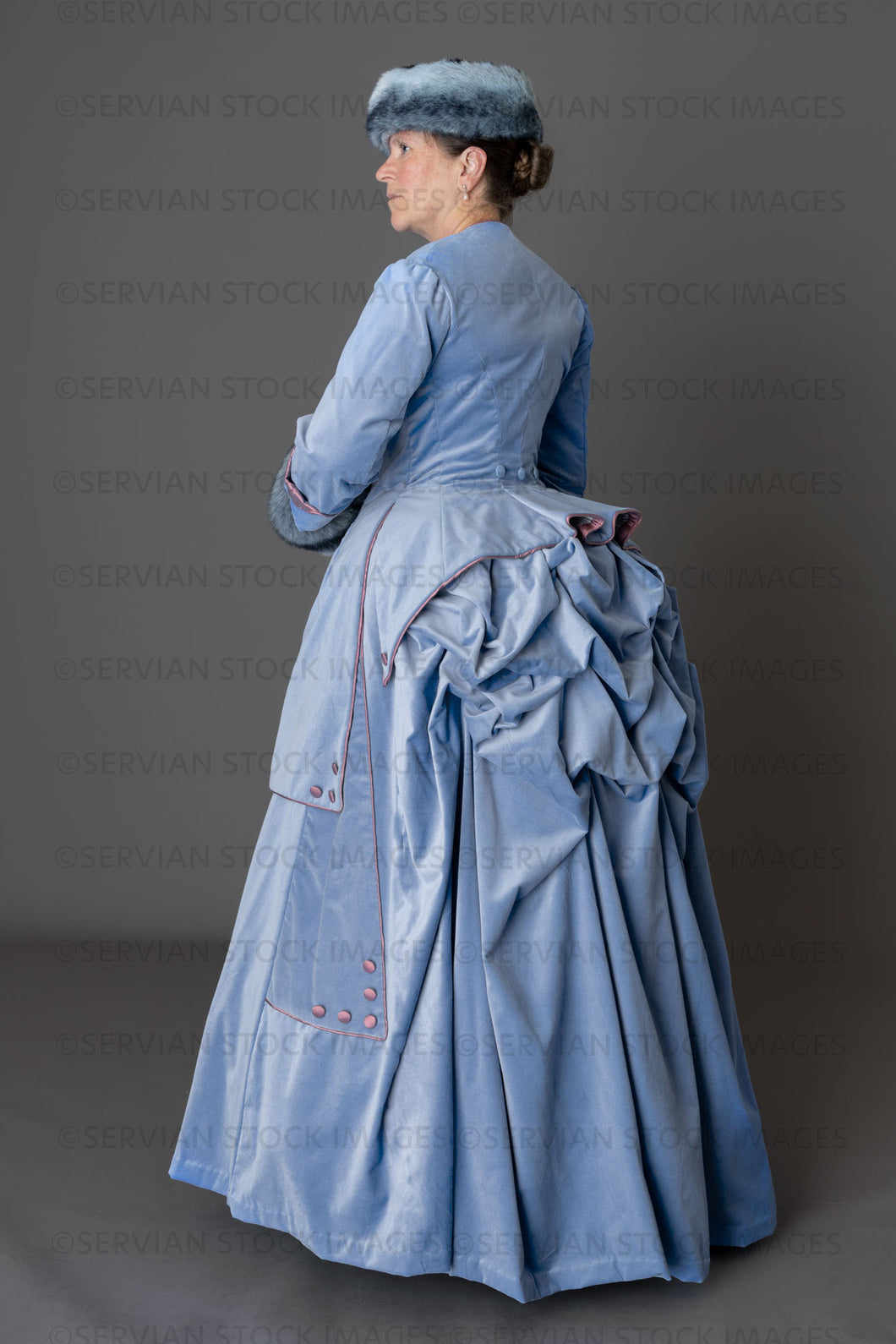 Victorian woman in a pale blue winter ensemble with fur muff and hat (Tracey 6222)