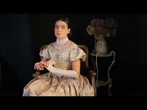 Video of Victorian woman wearing a gold bodice and skirt and looking bored  (Sarah 1499)