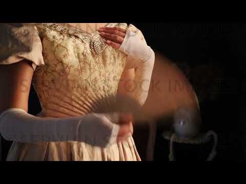 Video of Victorian woman wearing a gold bodice and skirt and using a fan (Sarah 1504-2)
