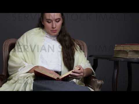 Victorian/Edwardian woman with long dark hair sits in a chair reading   (Sarah 1705)