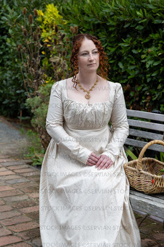 Regency woman wearing a day dress and sitting in a garden (Agnes 6943)