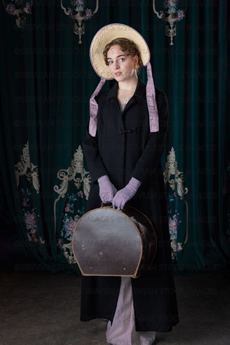 Regency woman wearing a travelling ensemble and holding a leather hat box (Viola 7152)