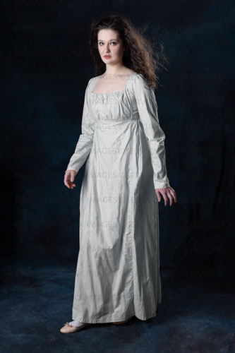 Regency woman wearing a blue cotton dress with her hair blowing in the wind (Brigit 8542)