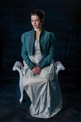 Regency woman wearing a blue cotton dress and a short spencer, and sitting on a wooden seat (Brigit 8567)