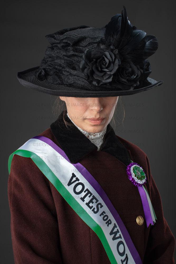 United Kingdom Suffragette from late 19th / early 20th century wearing a black hat and winter coat (SARAH 1018UK)