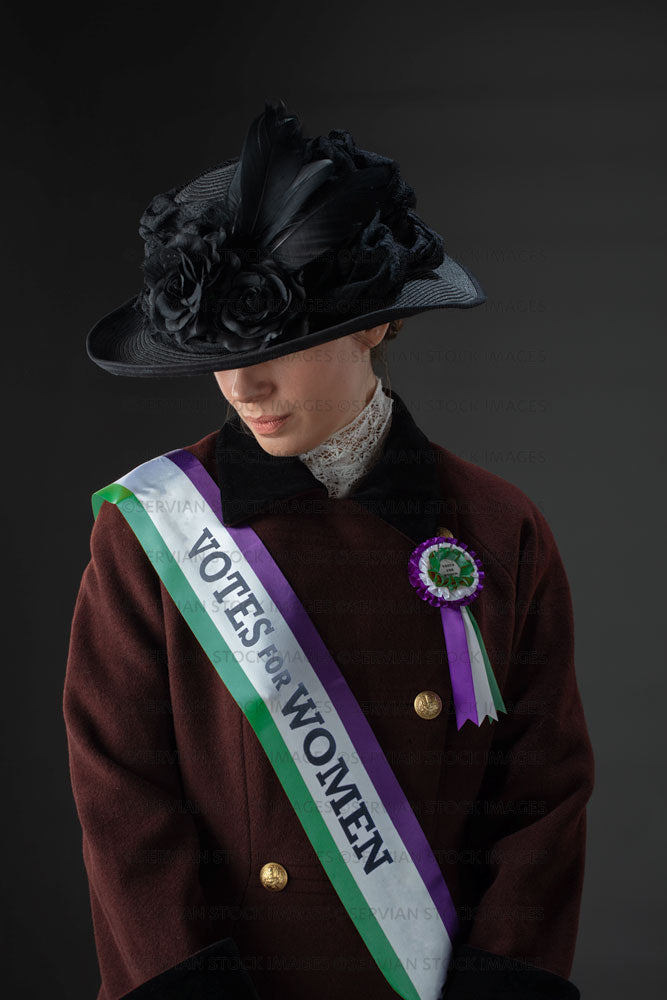 United Kingdom Suffragette from late 19th / early 20th century wearing a black hat and winter coat (SARAH 1020UK)