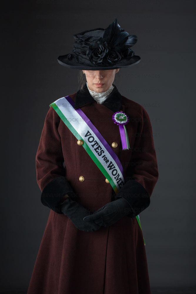 United Kingdom Suffragette from late 19th / early 20th century wearing a black hat and winter coat (SARAH 1029UK)