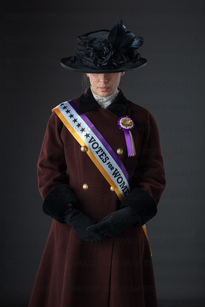 USA Suffragette from late 19th / early 20th century wearing a black hat and winter coat (SARAH 1029)