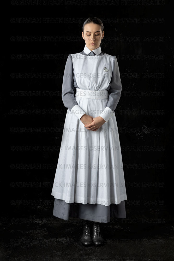 World War 1 nurse in grey uniform dress with a white apron (Sarah537)