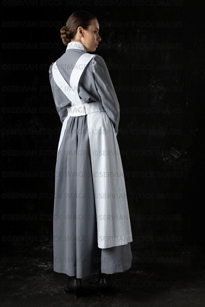 World War 1 nurse in grey uniform dress with a white apron (Sarah564)