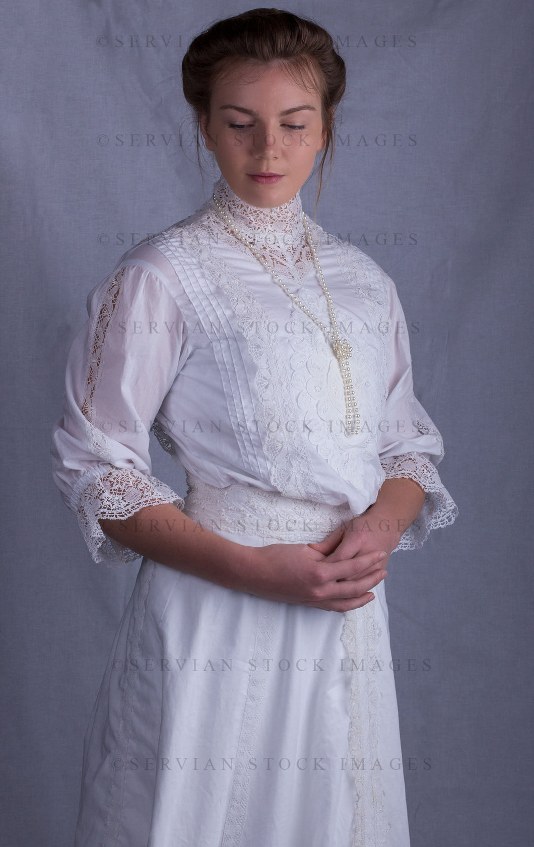 Edwardian woman in a white lace blouse and skirt with a pearl necklace (Tayla 0030)