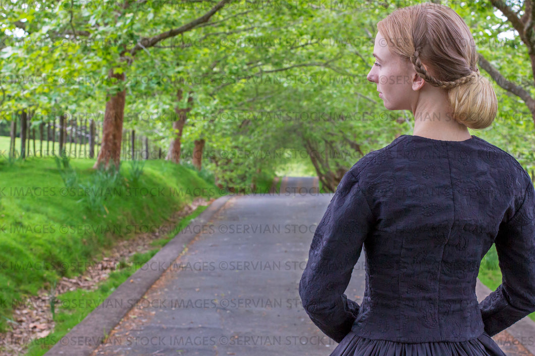 Victorian woman in a black ensemble outdoors under a grove of trees   (Ashley 0045)
