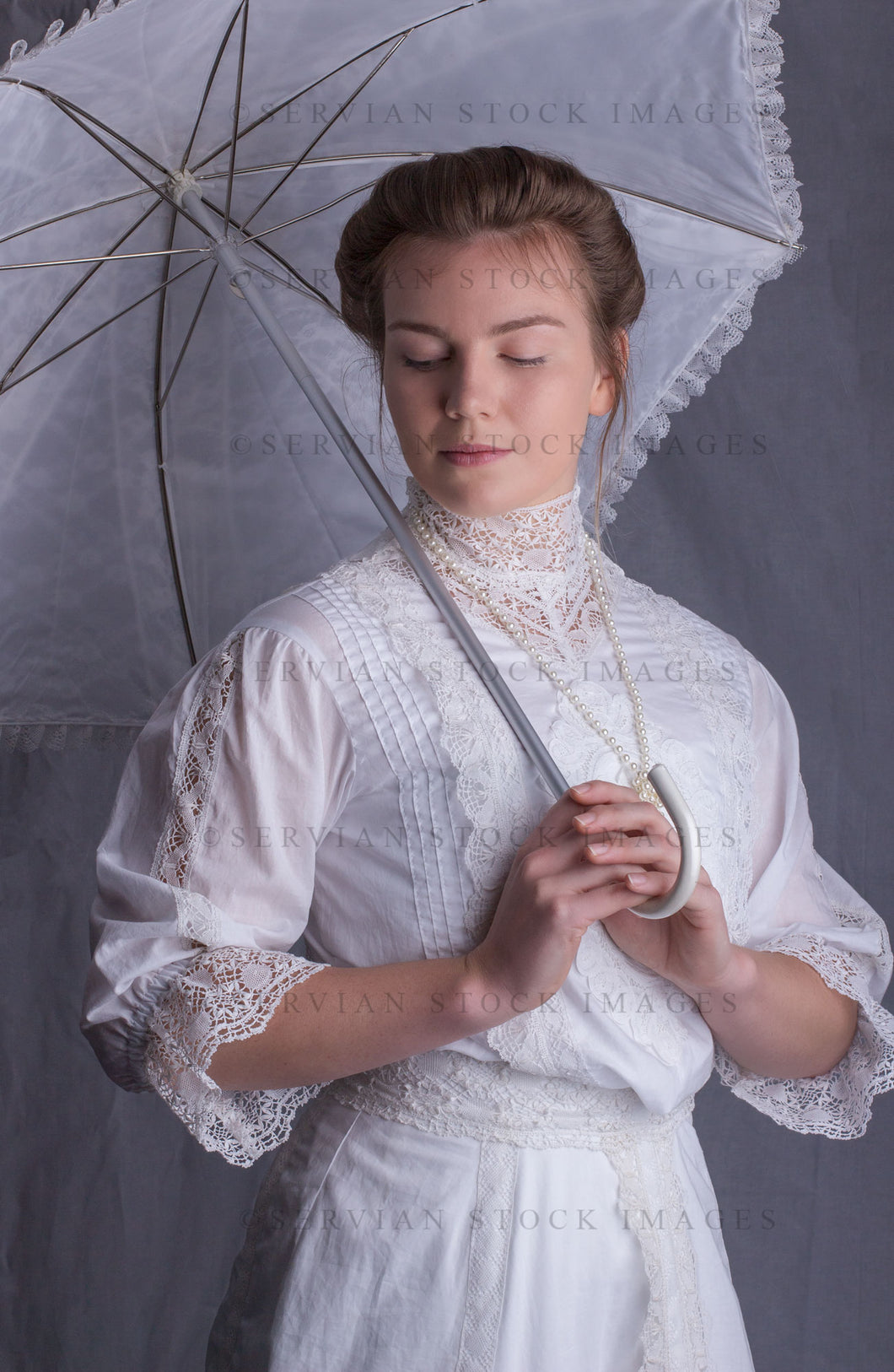 Edwardian woman in a white lace blouse and skirt with a pearl necklace (Tayla 0047)