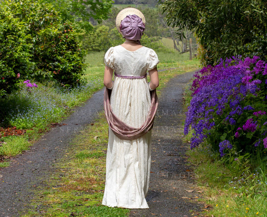 Regency woman in a cream embroidered dress and long gloves and walking in the country (Skye 0132)