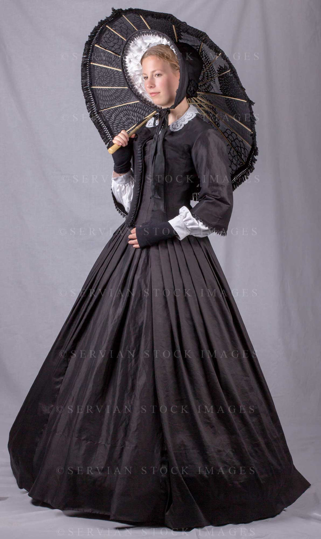 Victorian woman wearing a black bodice and skirt and holding a parasol (Skye 0193)