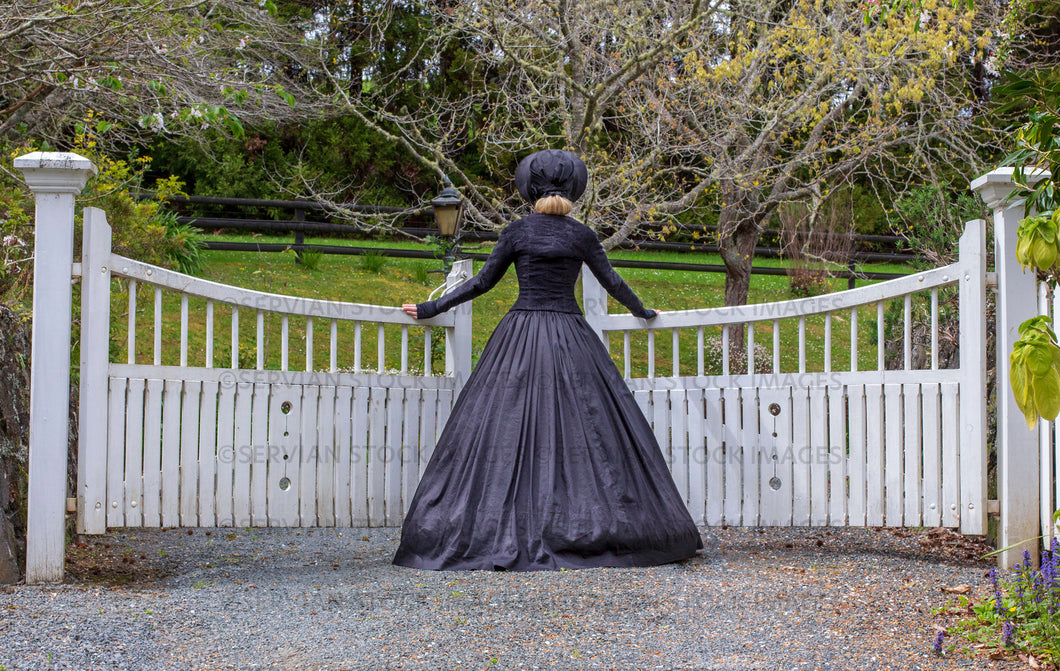 Victorian woman in a black ensemble outdoors under a grove of trees   (Ashley 0197)
