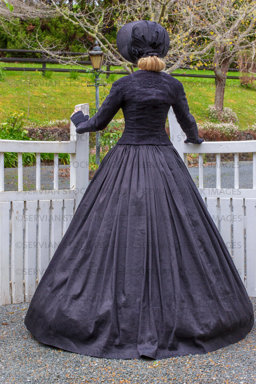 Victorian woman in a black ensemble outdoors  (Ashley 0200)