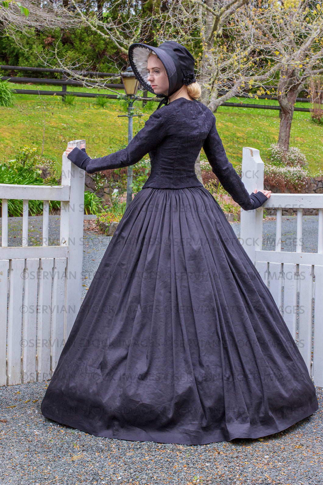 Victorian woman in a black ensemble outdoors  (Ashley 0204)
